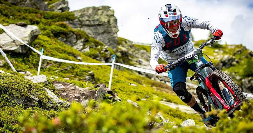 Biker riding a mountain bike on rocks.